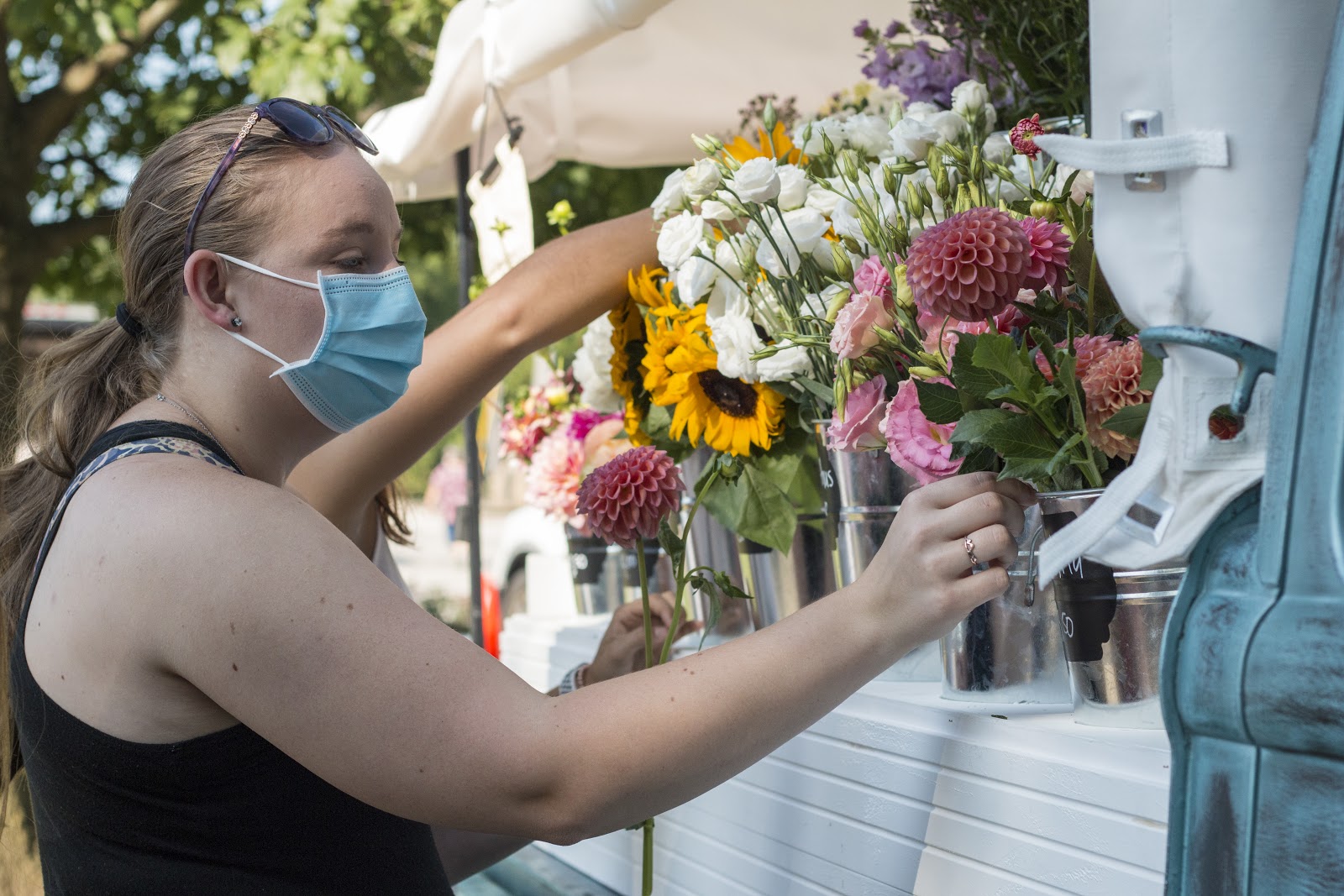 A customer brings friends to experience the joy of picking a personal bouquet at the Woodville Farmer’s Market. Photo by Joni Johnson.